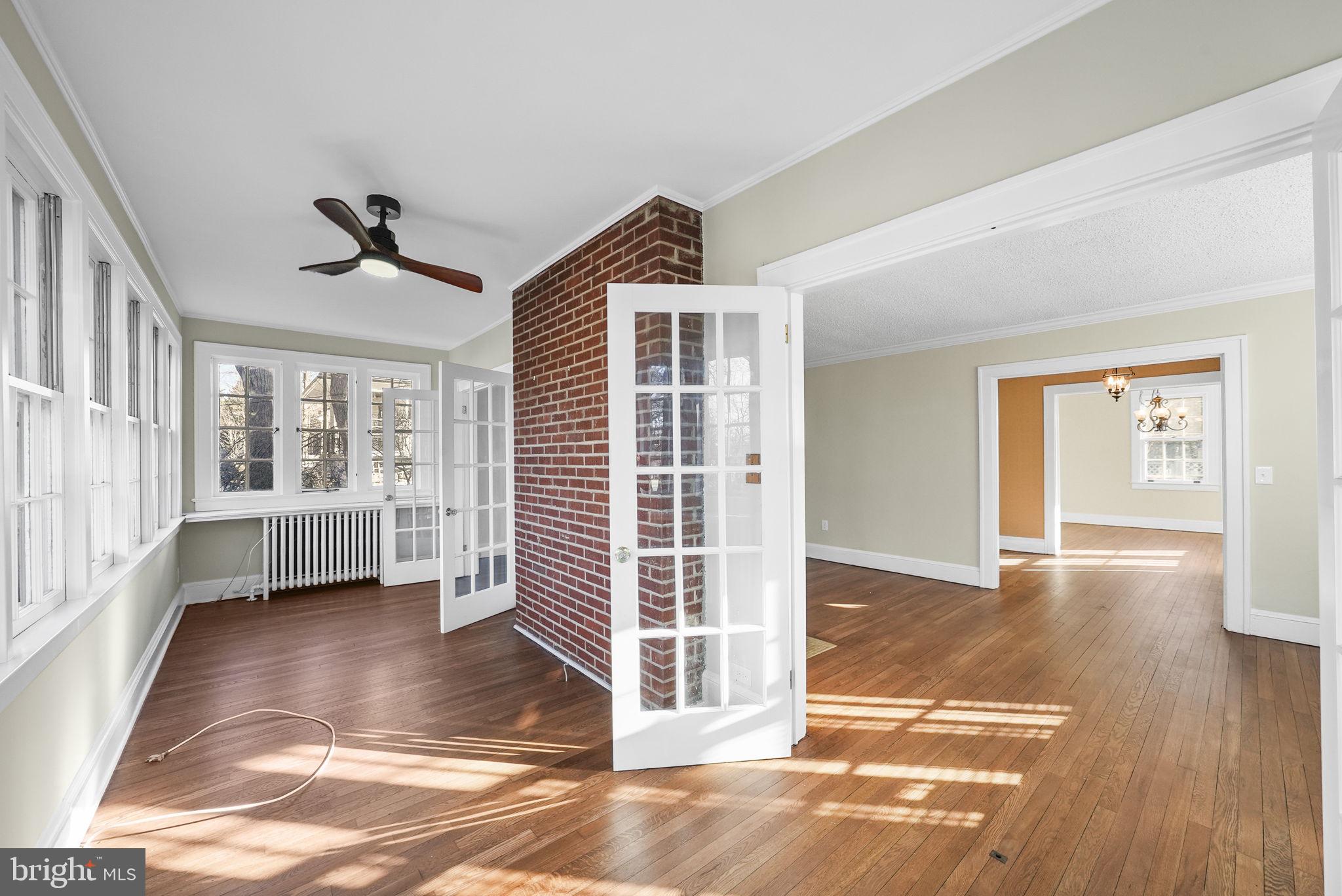 2046 Pennington Road Ewing, NJ 08618 - Photo 6 of 37 a view of empty room with wooden floor and fan