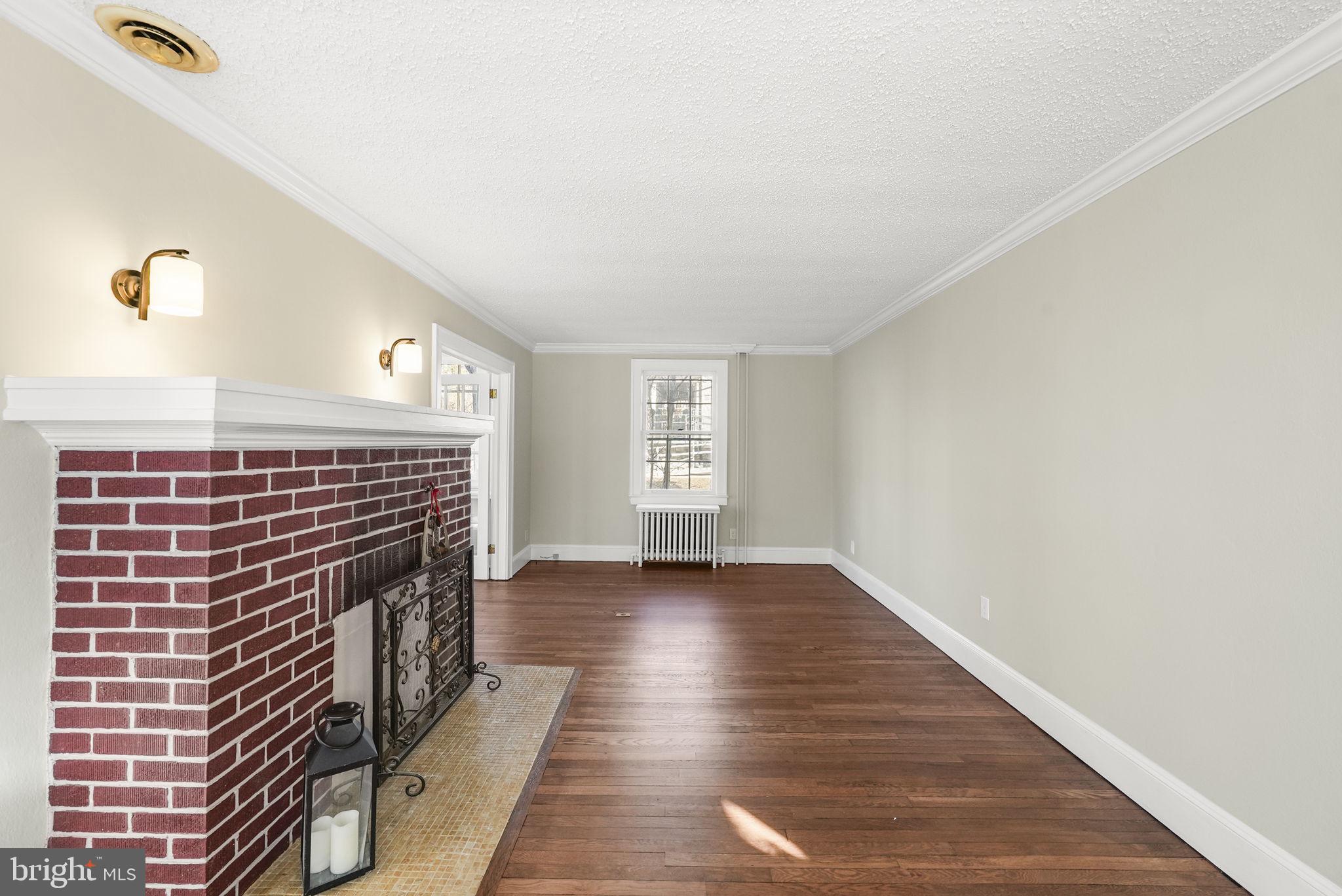 2046 Pennington Road Ewing, NJ 08618 - Photo 7 of 37 a view of an empty room with wooden floor and a window