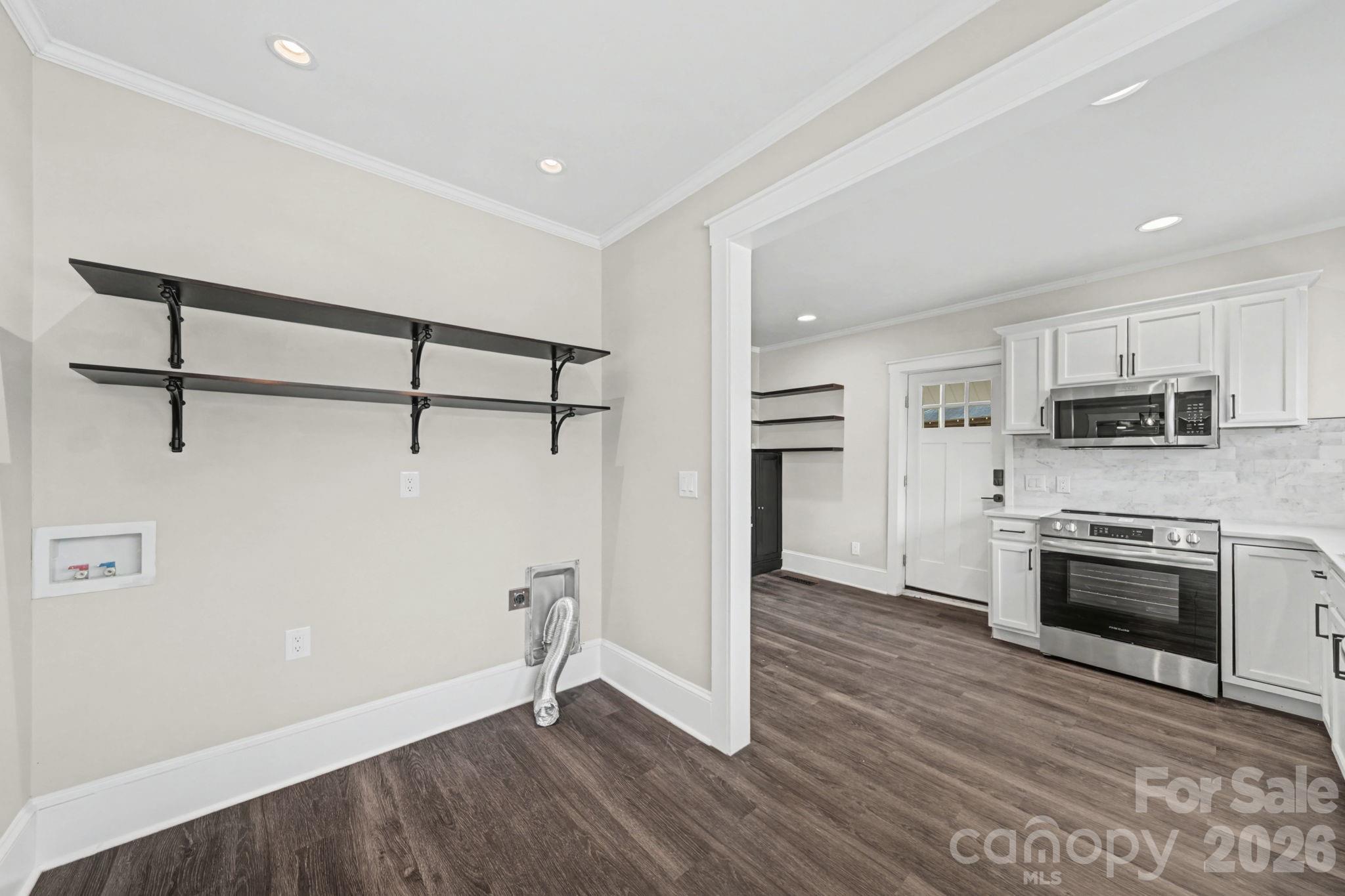 1132 East Main Street Albemarle, NC 28001 - Photo 13 of 25 a view of a kitchen with a sink stove refrigerator and cabinets