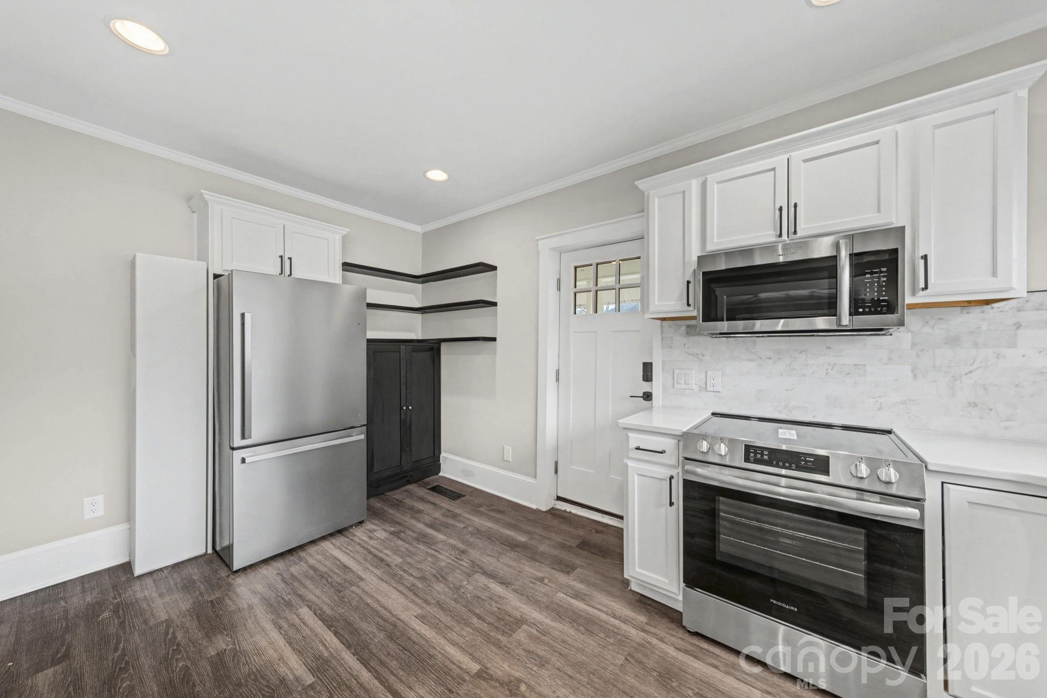 1132 East Main Street Albemarle, NC 28001 - Photo 15 of 25 a kitchen with a refrigerator stove and microwave