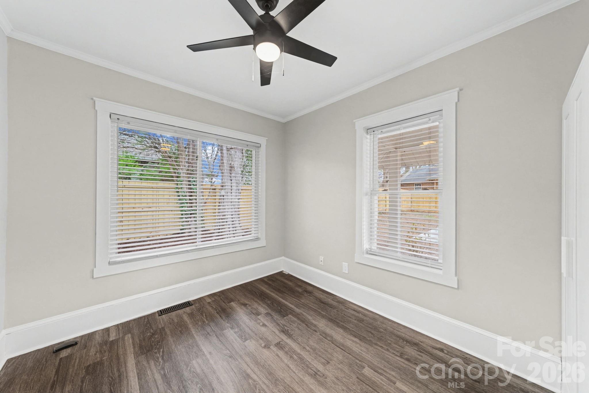 1132 East Main Street Albemarle, NC 28001 - Photo 16 of 25 a view of an empty room with wooden floor and a window