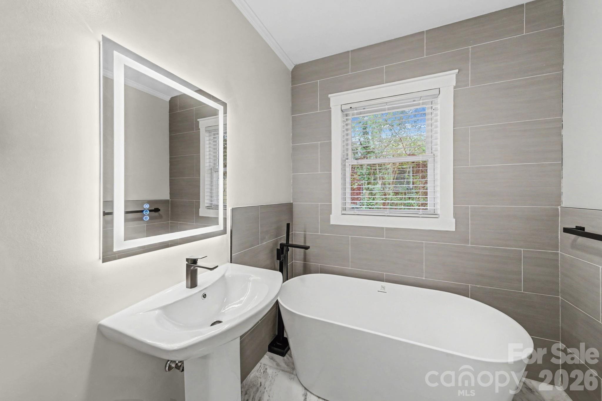 1132 East Main Street Albemarle, NC 28001 - Photo 18 of 25 a white bath tub sitting next to a white sink