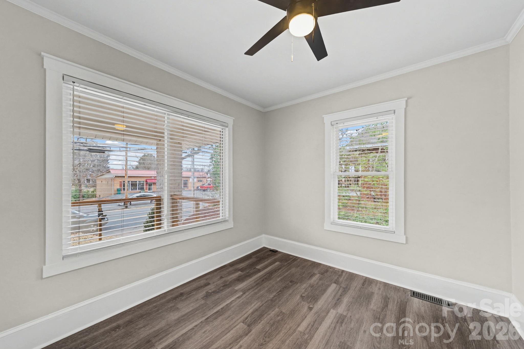 1132 East Main Street Albemarle, NC 28001 - Photo 22 of 25 a view of an empty room with wooden floor and a window