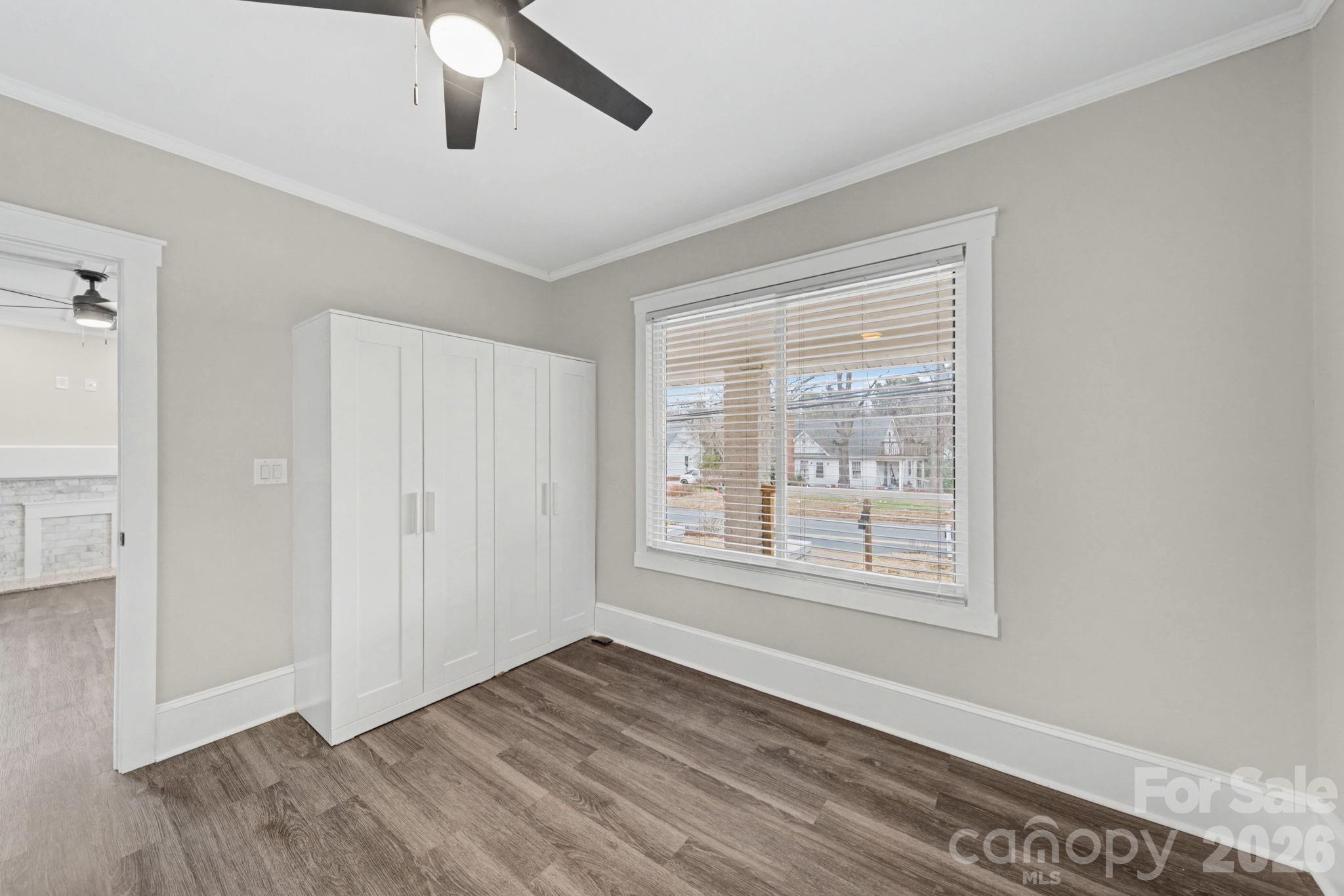 1132 East Main Street Albemarle, NC 28001 - Photo 23 of 25 a view of an empty room with wooden floor and a window