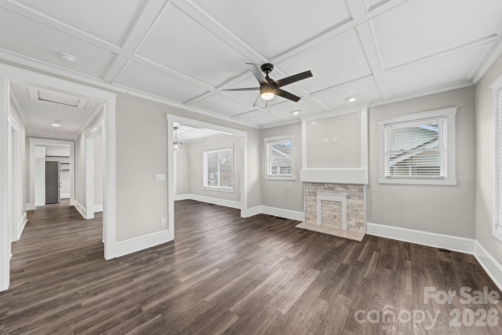 1132 East Main Street Albemarle, NC 28001 - Photo 8 of 25 a view of empty room with wooden floor and fan