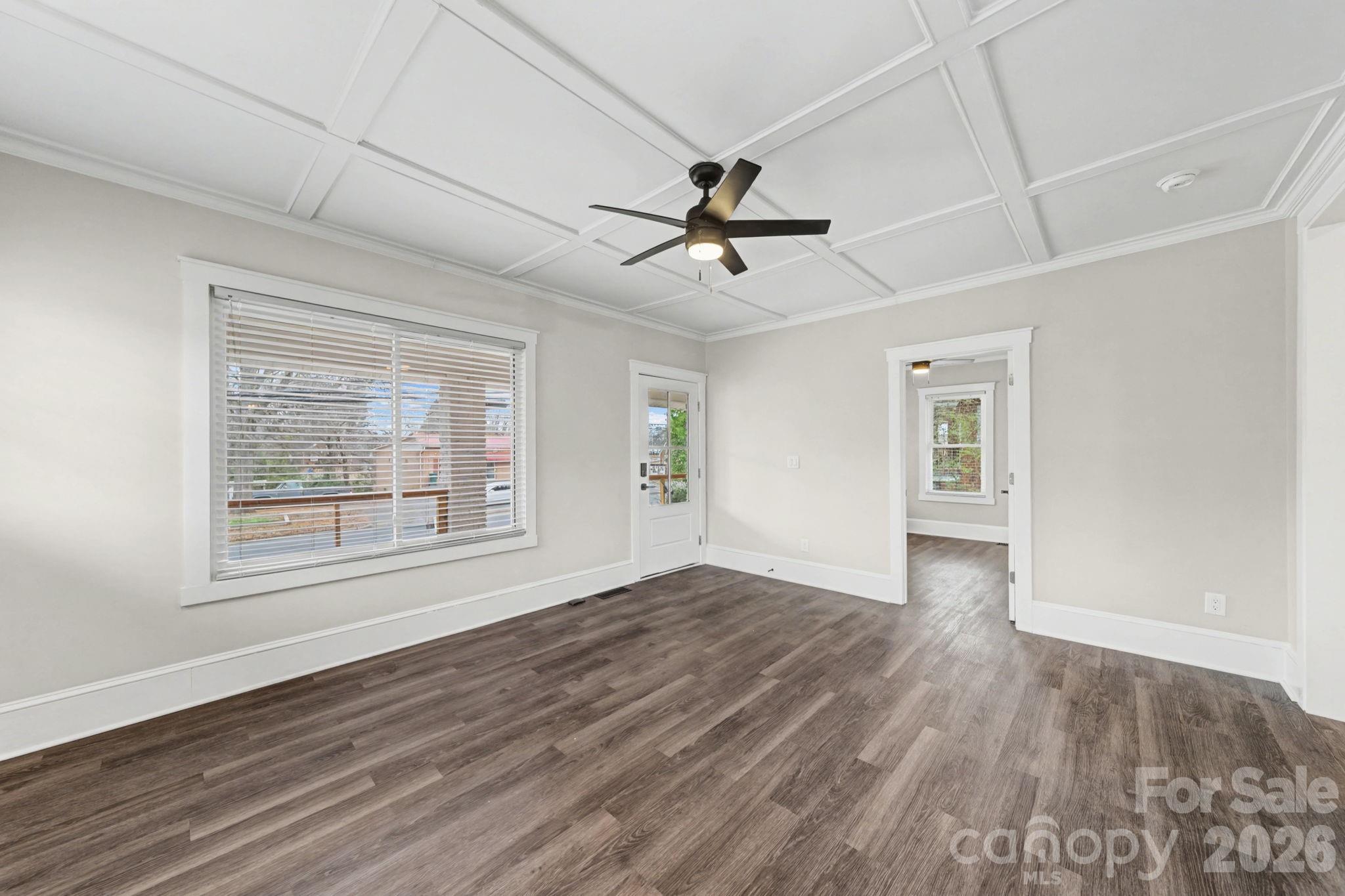 1132 East Main Street Albemarle, NC 28001 - Photo 9 of 25 a view of empty room with wooden floor and fan