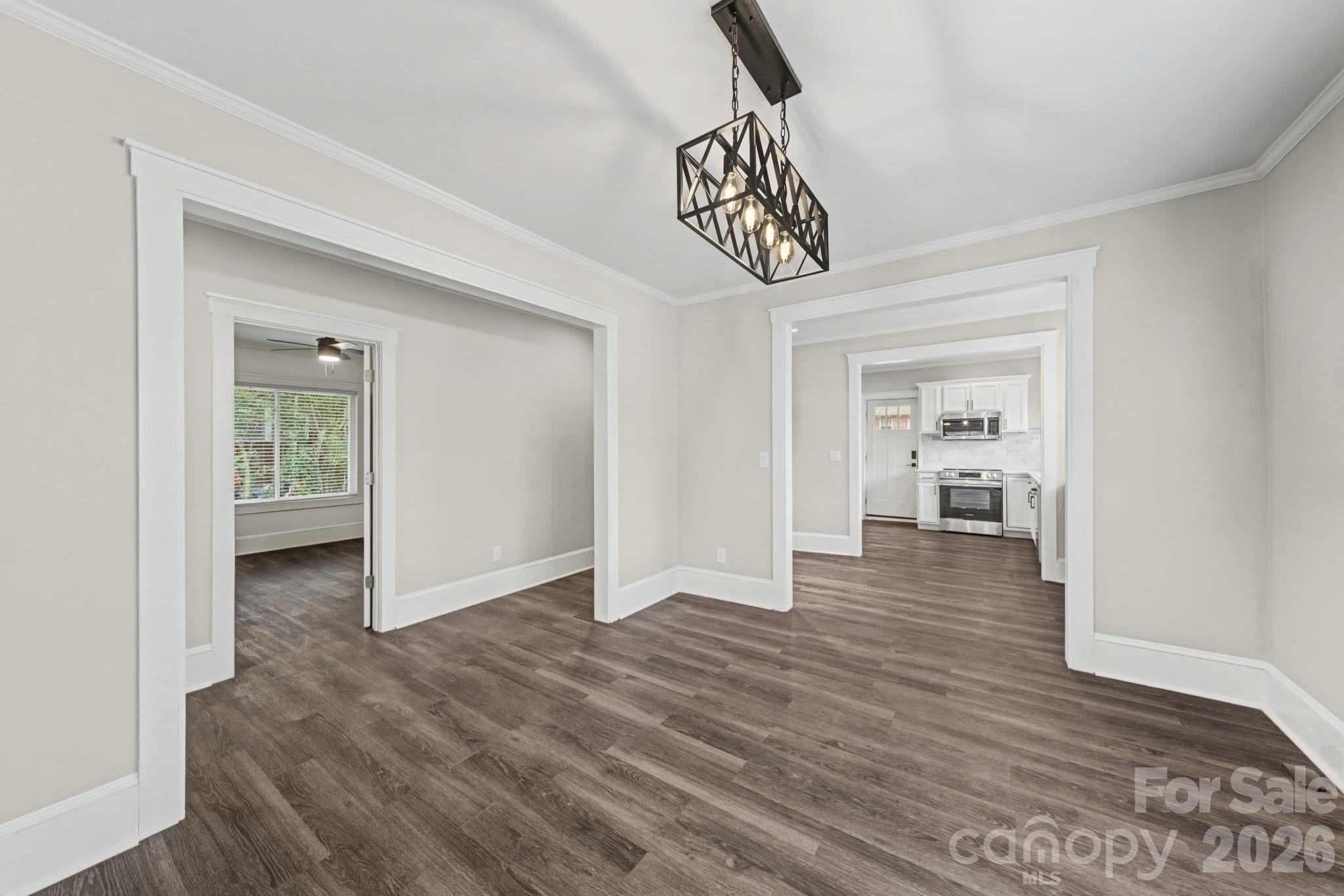 1132 East Main Street Albemarle, NC 28001 - Photo 10 of 25 a view of a hallway with wooden floor and a bathroom