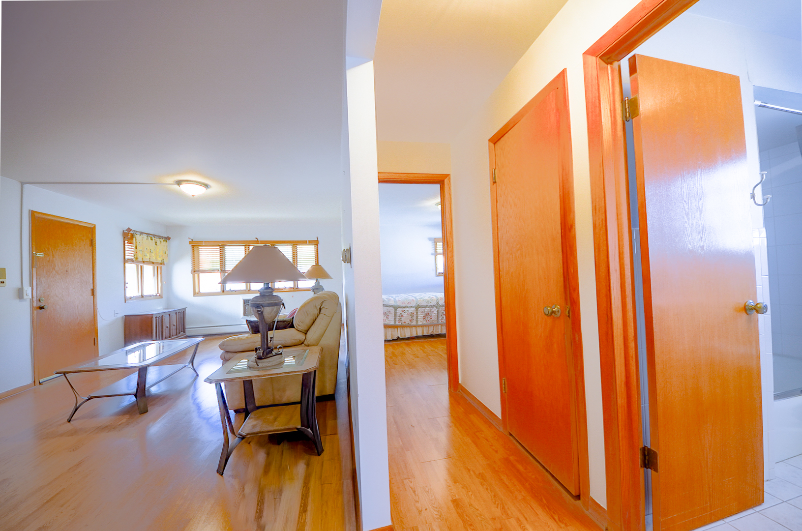 8216 West Belmont Avenue, Unit 2N Chicago, IL 60634 - Photo 11 of 11 a living room with furniture floor to ceiling window and wooden floor
