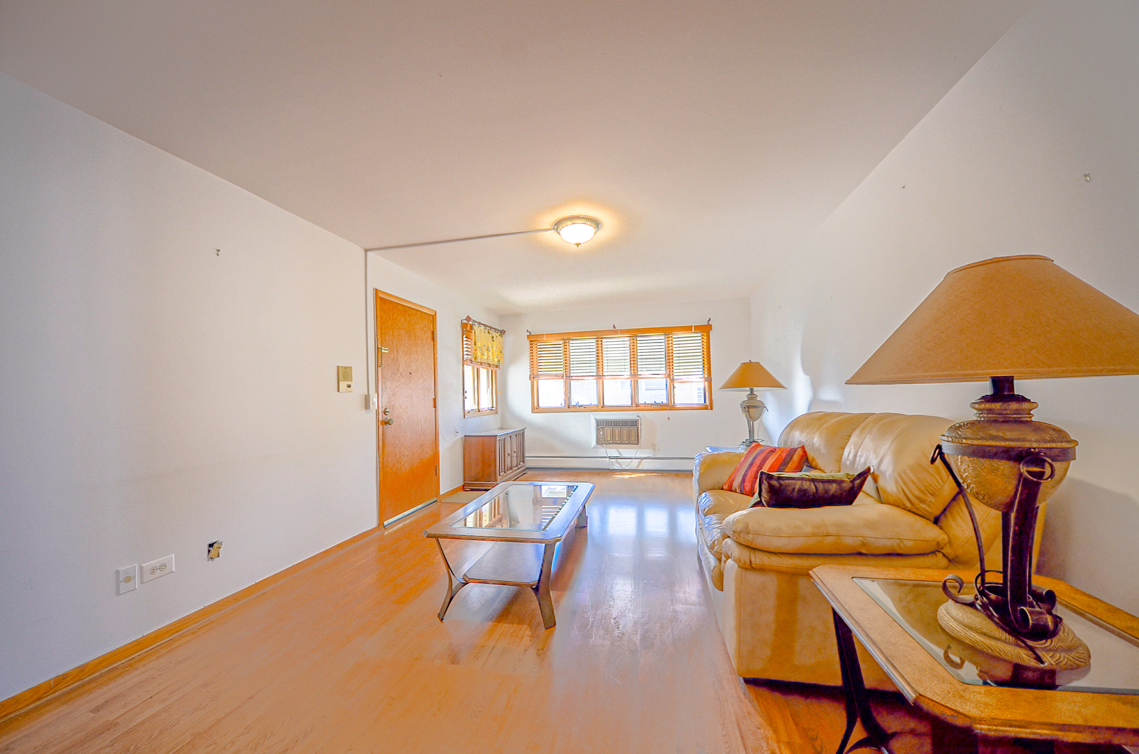 8216 West Belmont Avenue, Unit 2N Chicago, IL 60634 - Photo 3 of 11 a living room with dining room and wooden floor