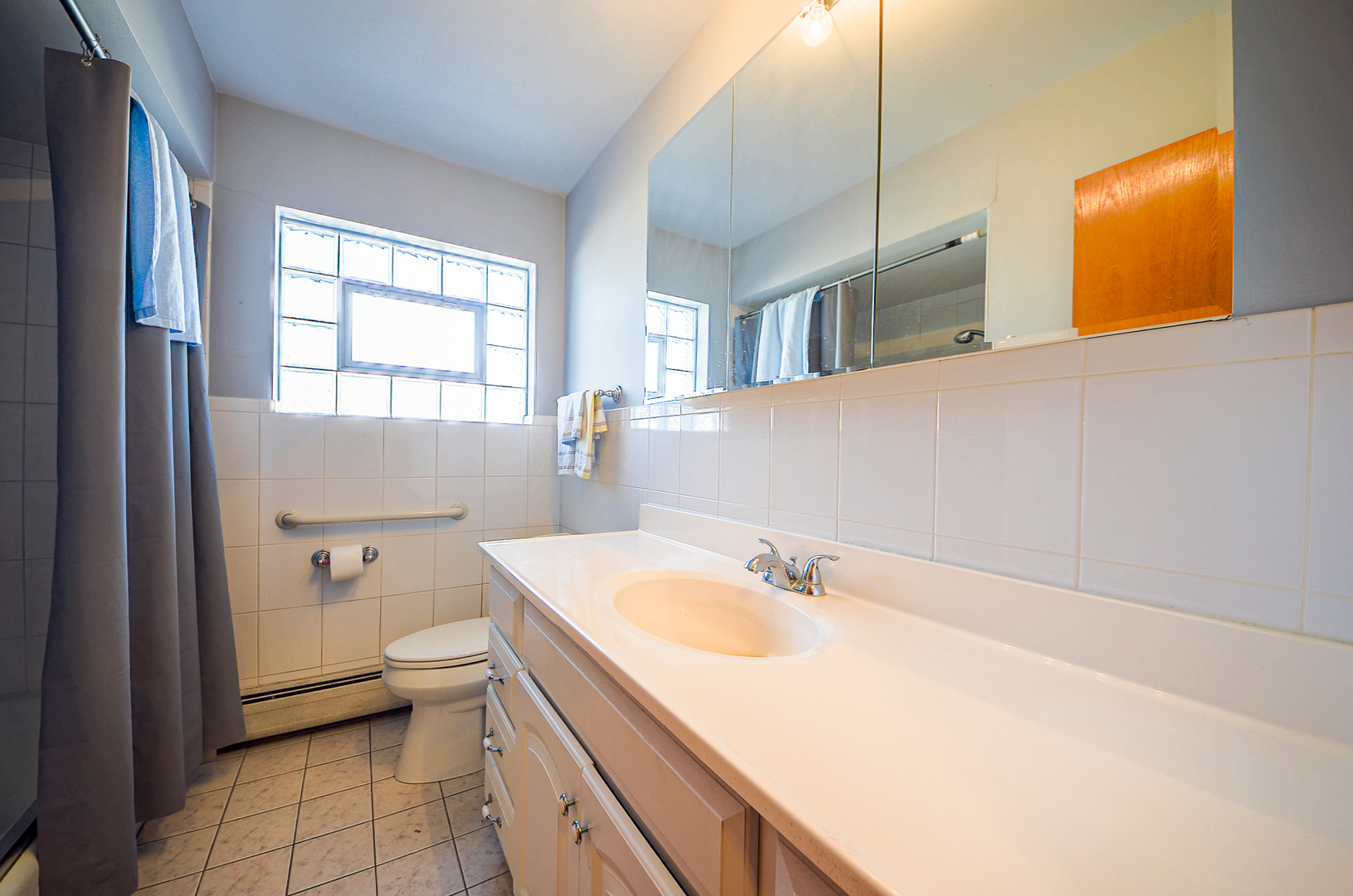 8216 West Belmont Avenue, Unit 2N Chicago, IL 60634 - Photo 8 of 11 a bathroom with a sink toilet and shower