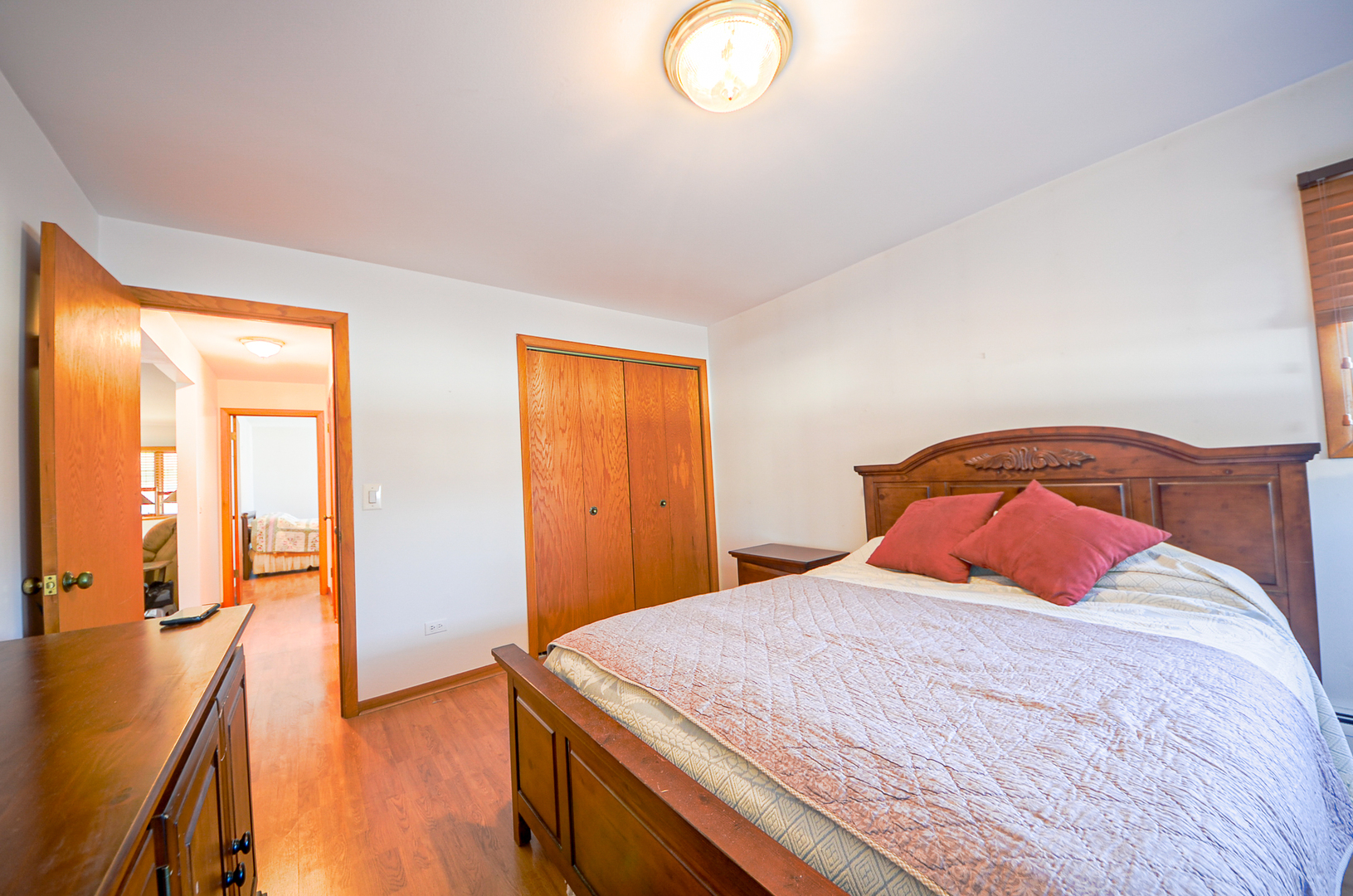 8216 West Belmont Avenue, Unit 2N Chicago, IL 60634 - Photo 10 of 11 a bedroom with a bed and wooden floor