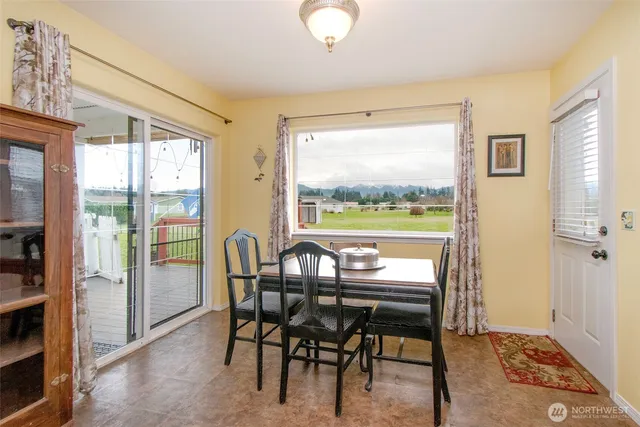 a view of a dining room with furniture window and outside view