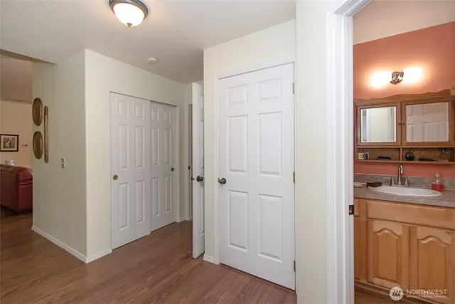 a view of a kitchen with a sink and a wooden floor
