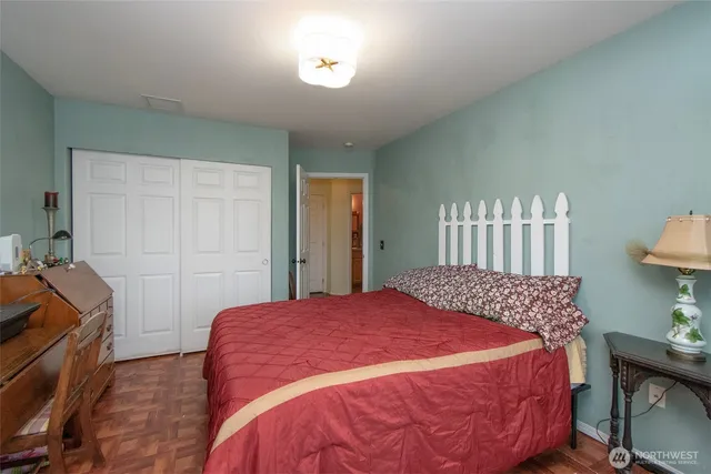 a bedroom with a bed and chair