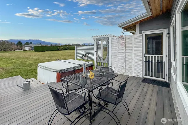 a view of a patio with wooden floor table and chairs