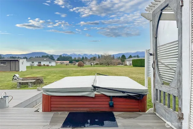 a view of a patio with table and chairs with wooden floor and fence