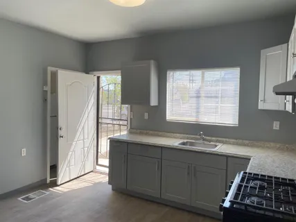 a view of a room with wooden floor