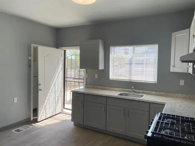 a view of a room with wooden floor