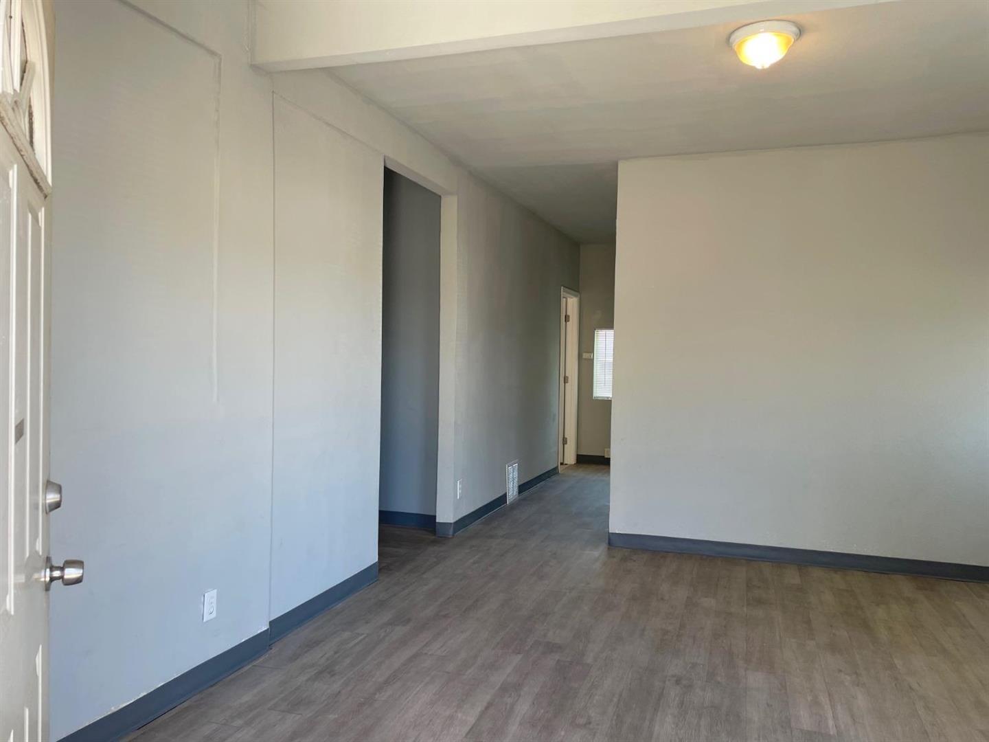 1217 East Harding Way Stockton, CA 95205 - Photo 3 of 5 a view of a room with wooden floor