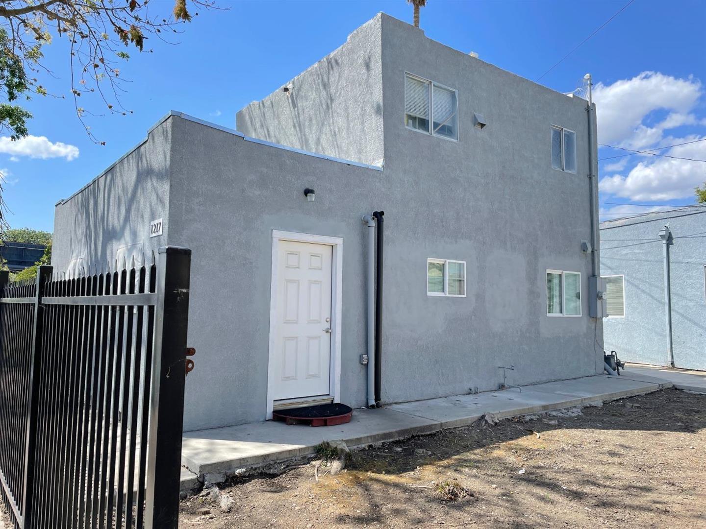 1217 East Harding Way Stockton, CA 95205 - Photo 4 of 5 a front view of a house with parking space
