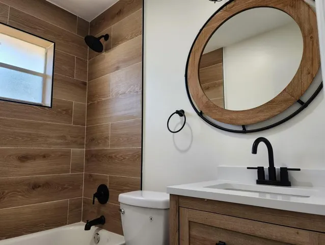 a bathroom with a sink mirror toilet and shower