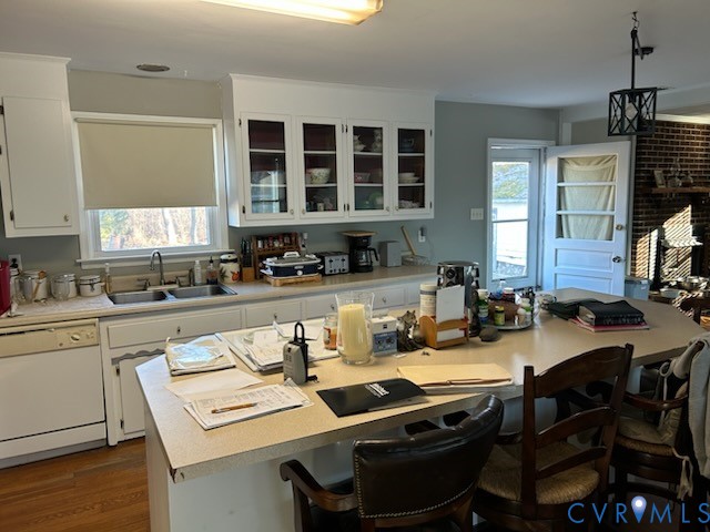 11707 Zilles Road Blackstone, VA 23824 - Photo 5 of 20 a kitchen with a stove a sink dishwasher a dining table and chairs with wooden floor