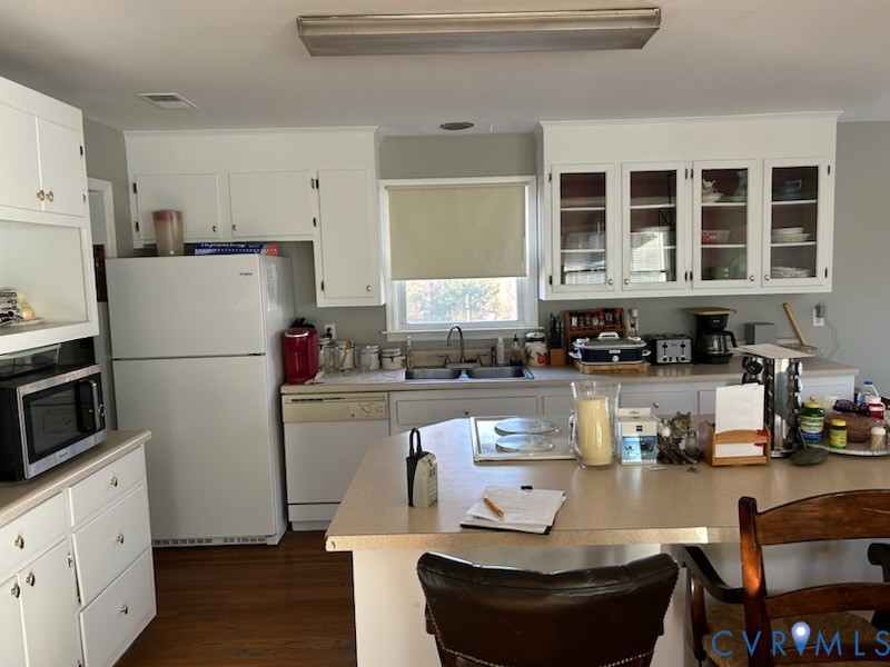 11707 Zilles Road Blackstone, VA 23824 - Photo 6 of 20 a kitchen with a refrigerator and white cabinets