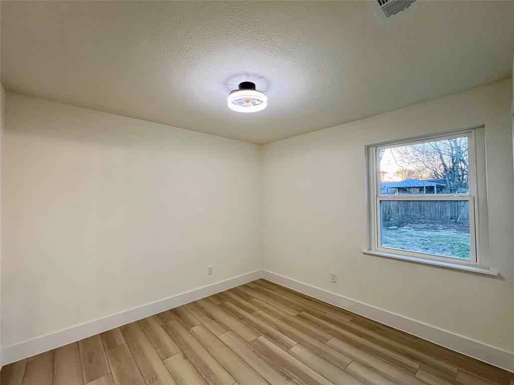 4211 Ridgedale Drive Mesquite, TX 75150 - Photo 9 of 11 an empty room with a window