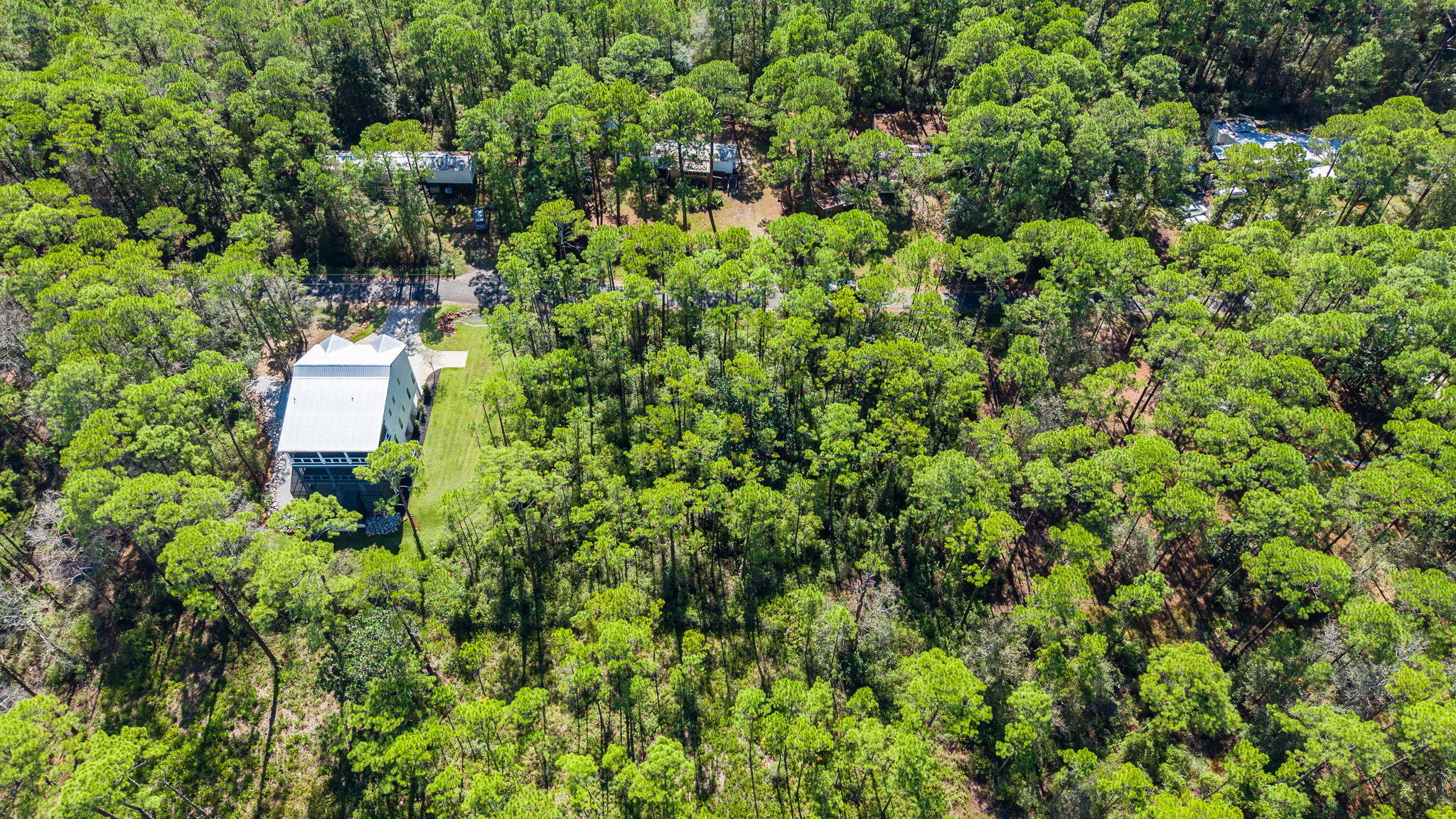 Lot 7-8 Crissman Road Santa Rosa Beach, FL 32459 - Photo 8 of 12 an aerial view of residential house with outdoor space and trees all around