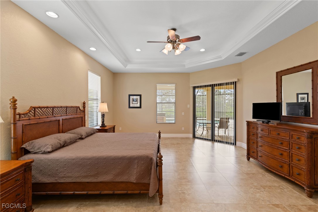 6057 Calusa Rdg Trail Bokeelia, FL 33922 - Photo 15 of 45 a spacious bedroom with a bed and wooden floor