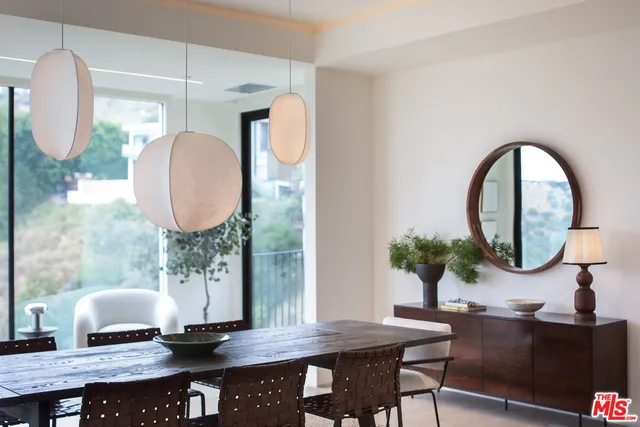 a view of a dining room with furniture and a mirror