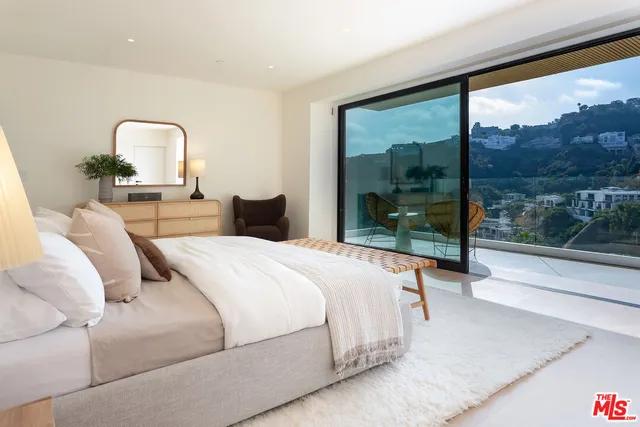 a bedroom with a large bed and a window