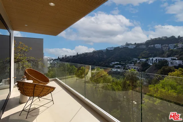 a view of a balcony with chair and table
