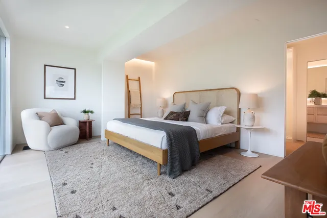 a bedroom with bed and a couch