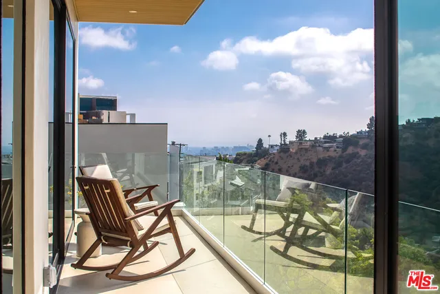a view of a balcony with chair and table