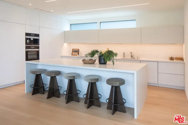 a kitchen with stainless steel appliances a sink and cabinets