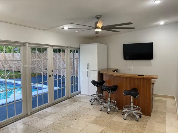 a view of a livingroom with workspace and a window