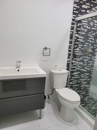 a bathroom with a sink a toilet and a mirror