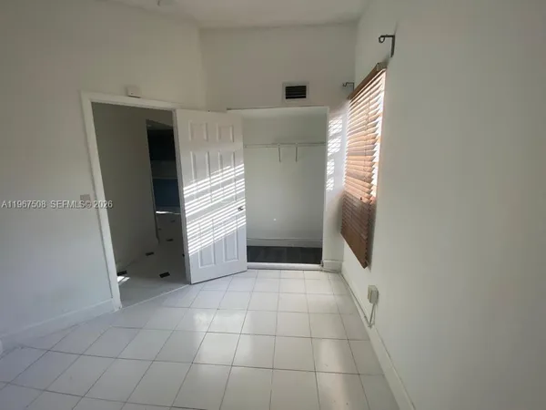 a view of a hallway to rooms and stairs