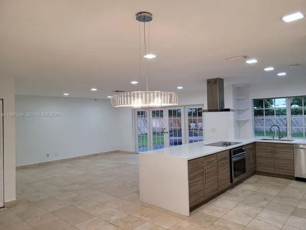 a kitchen with stainless steel appliances granite countertop a stove and a sink