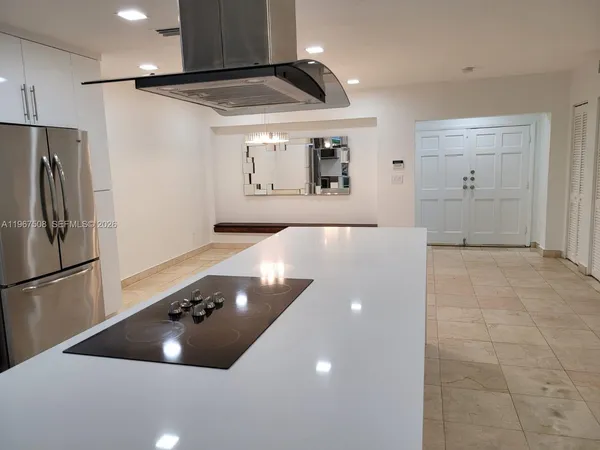 a kitchen with a refrigerator a stove and a sink