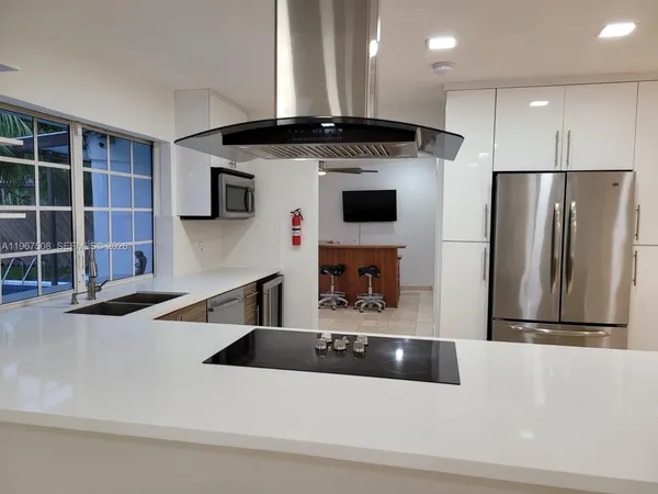 a kitchen with a refrigerator and a sink