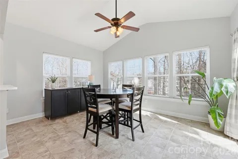 a view of a dining room with furniture and a window