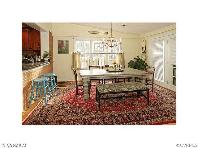 2650 Radstock Road Midlothian, VA 23113 - Photo 4 of 12 a living room with a dining table wooden floor and a chandelier