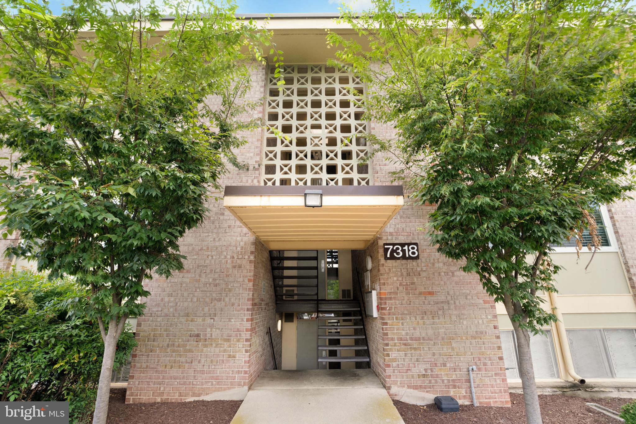 7318 Donnell Place, Unit C4 District Heights, MD 20747 - Photo 1 of 14 a front view of a house with a garden
