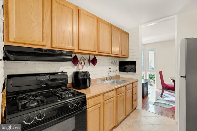 a kitchen with stainless steel appliances granite countertop a stove and a microwave