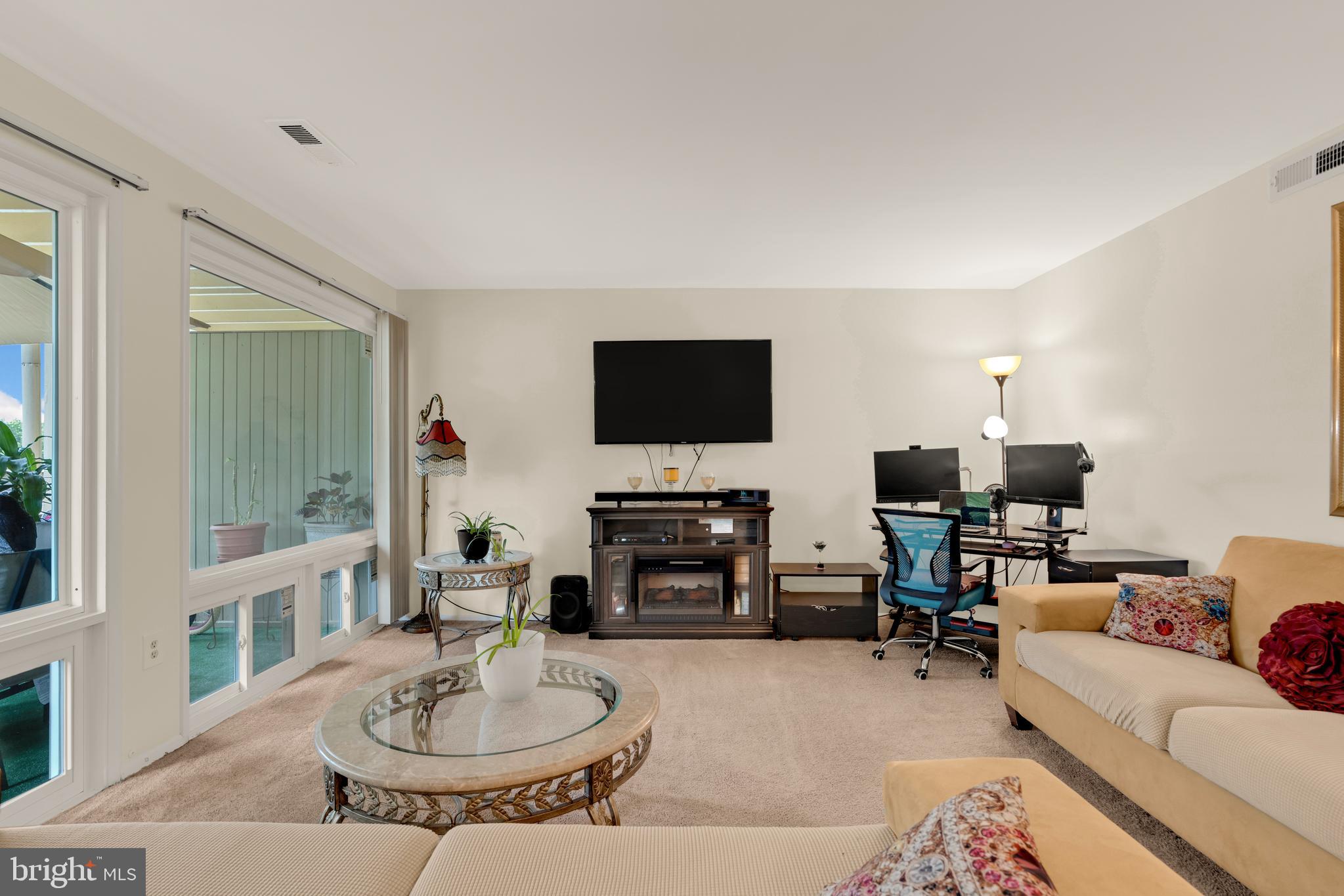 7318 Donnell Place, Unit C4 District Heights, MD 20747 - Photo 3 of 14 a living room with furniture a fireplace and a flat screen tv