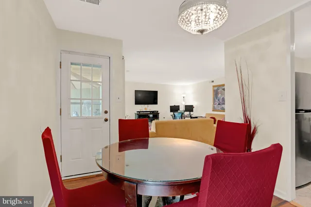 a living room with furniture a flat screen tv and a window