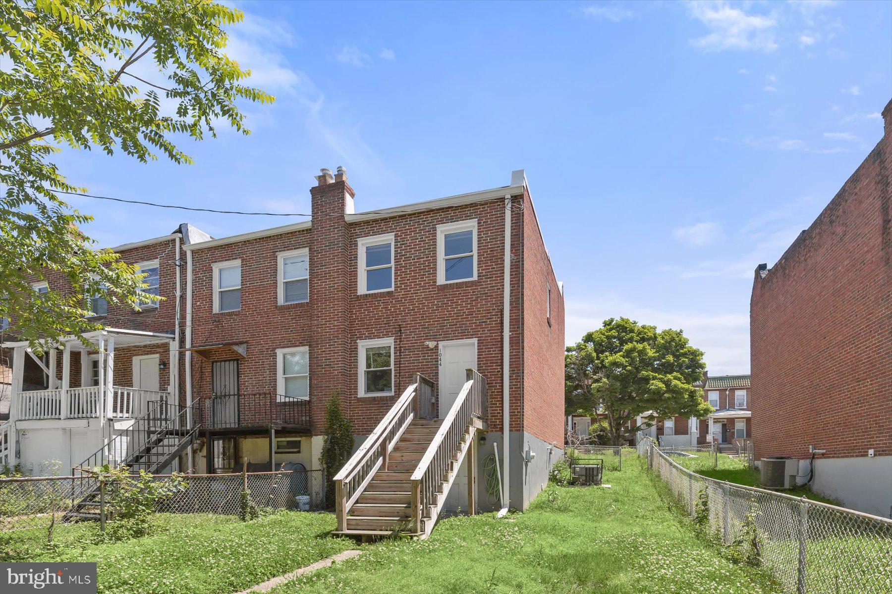 1044 Ellicott Driveway Baltimore, MD 21216 - Photo 20 of 26 a front view of a house with a yard