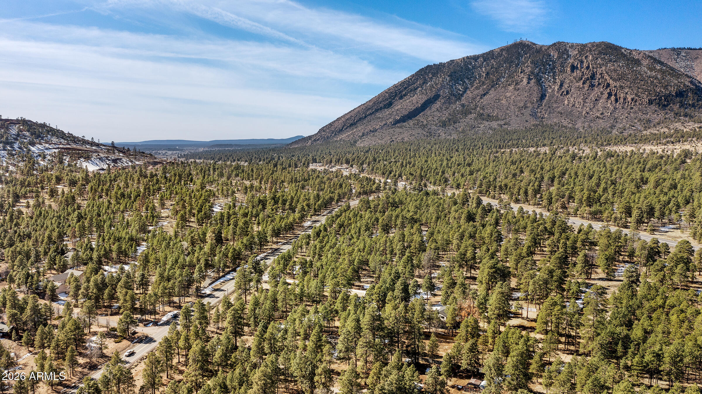 5055 Townsend-Winona Road, Unit 3 Flagstaff, AZ 86004 - Photo 5 of 11 a view of a large building with mountains in the background
